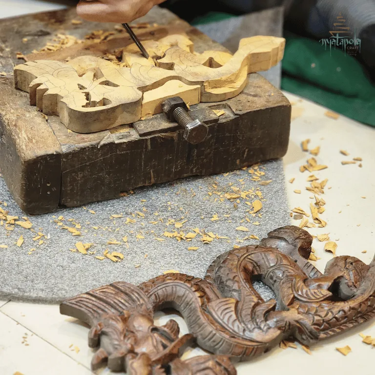 An intermediate student carving at the workshop